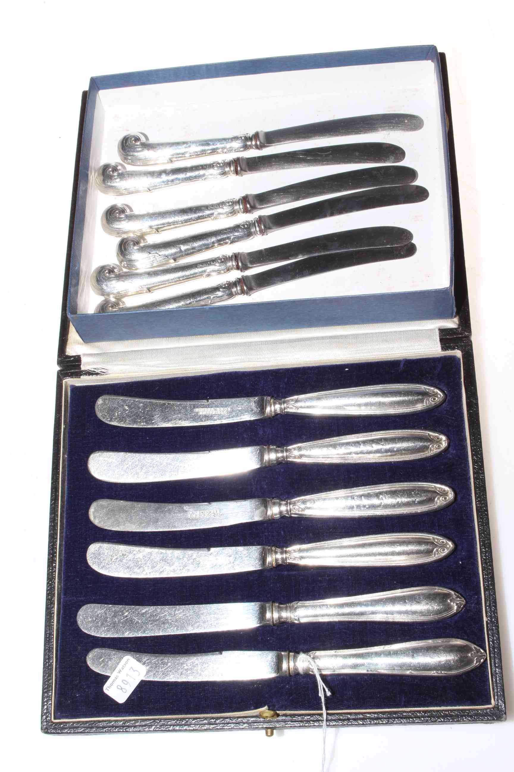 Two sets of cased six silver handled tea knives, one pistol grip.