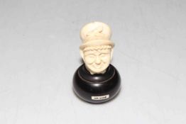 Late 19th Century carved ivory head of Dickens character Mrs Gamp, on bulbous base with name inset,