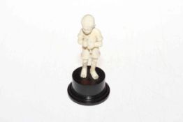 1920's well carved ivory figure of young boy with fish, on plinth base, 13cm.