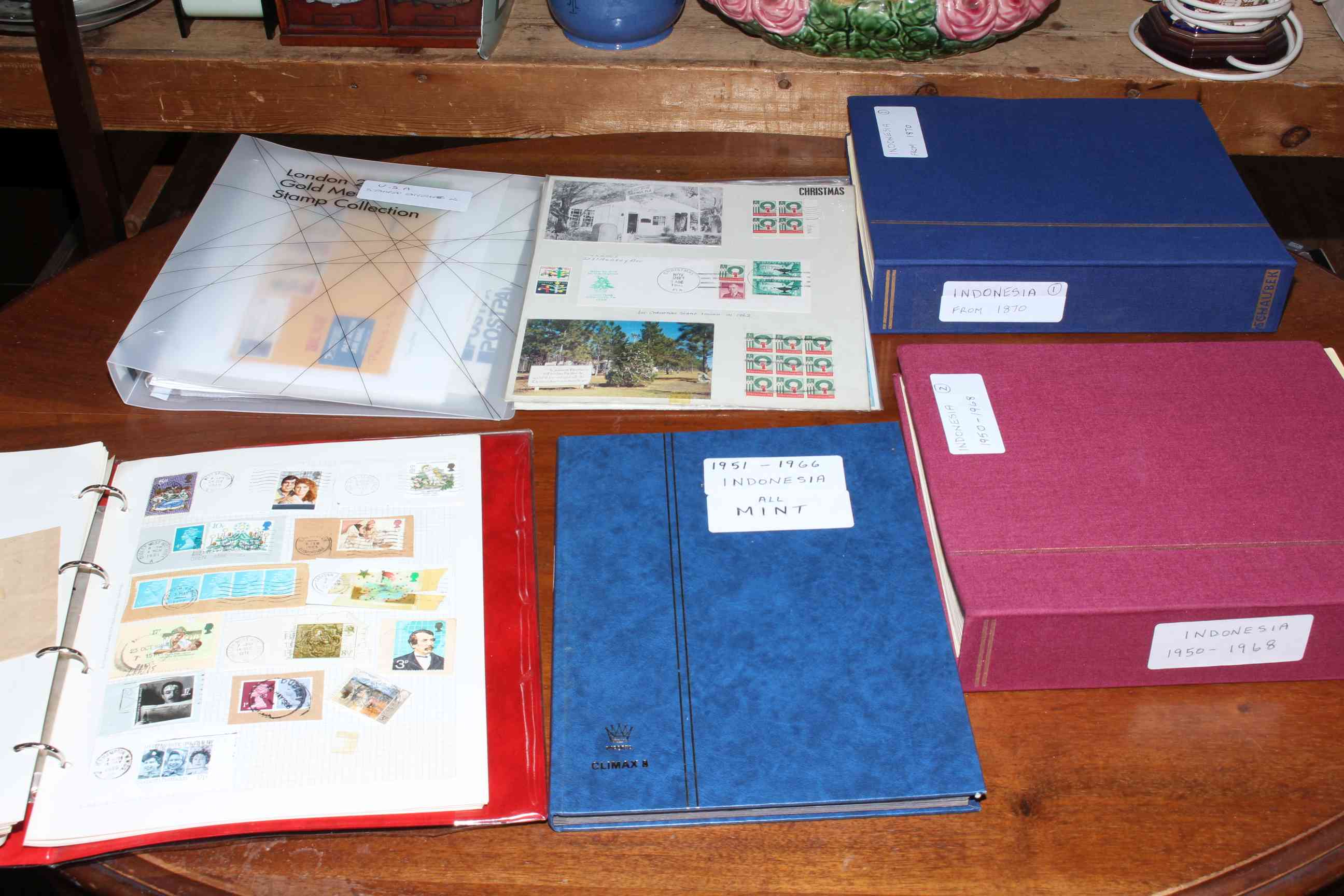 Box of stamp albums containing USA, Indonesian and other stamps.