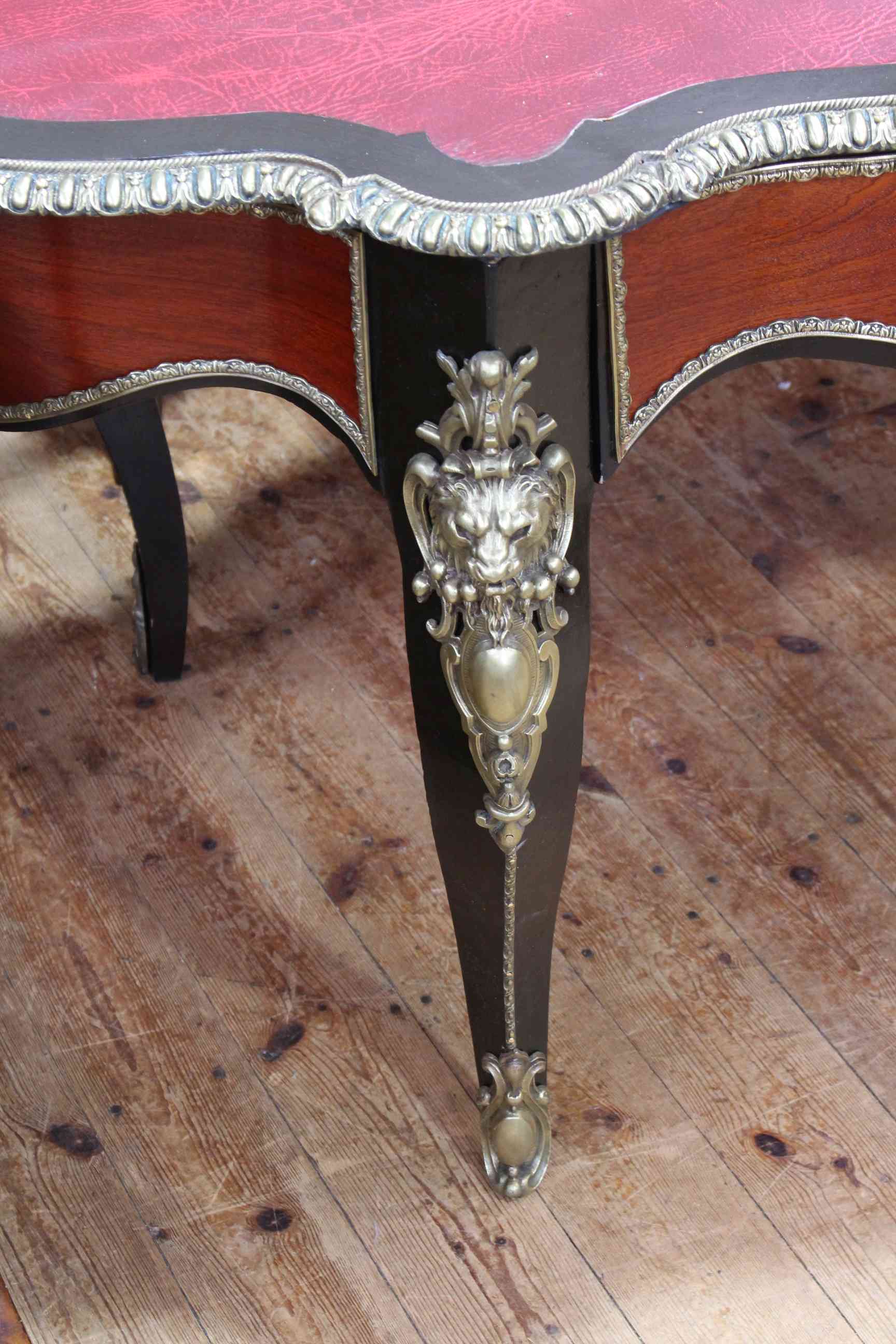 French ebonised and gilt metal mounted bureau plat, of oval shape with inset red leather, - Image 3 of 3