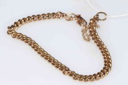 Gold chain link bracelet with safety chain.