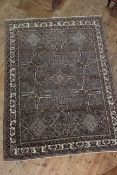 Persian design wool carpet with a brown ground, 3.10 by 2.05.