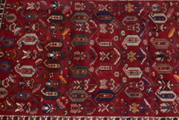 Hand knotted Iranian wool carpet with a red ground, 2.66 by 2.