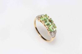 Tourmaline and diamond 18k yellow gold ring having three tourmaline and thirty two small diamonds,