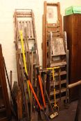 Three pairs of vintage wooden steps, step stool and collection of long handled tools.