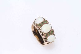 9 carat gold three stone opal and tiny emeralds ring, size J.