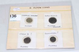 Four Roman coins.