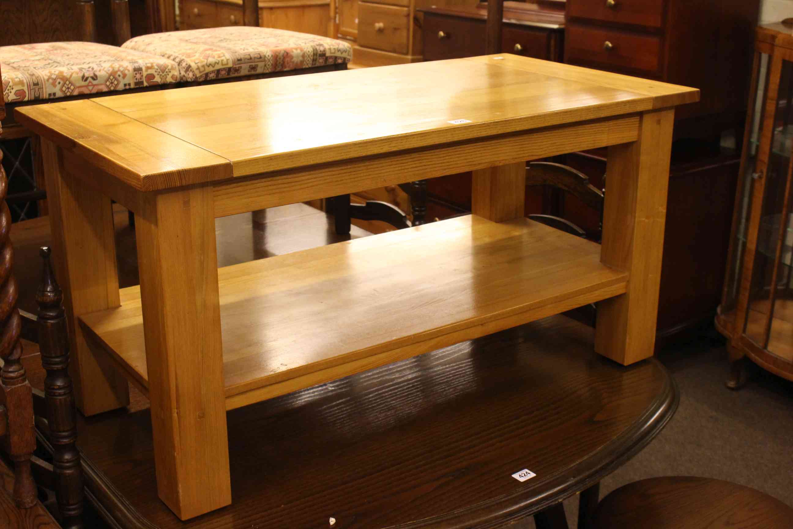 Light oak rectangular coffee table with undershelf, 51cm by 100cm by 50cm.