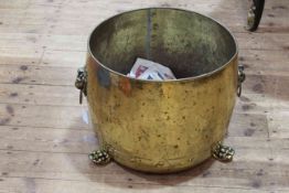 Brass coal cauldron with lion mask handles and paw feet, 34cm by 41cm diameter.