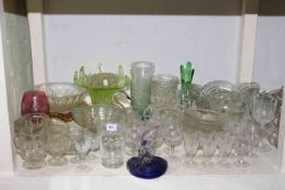 Collection of clear and green glassware including vases, decanters, bowls, etc.