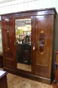 Edwardian inlaid mahogany wardrobe having central mirror door flanked by two inlaid doors,