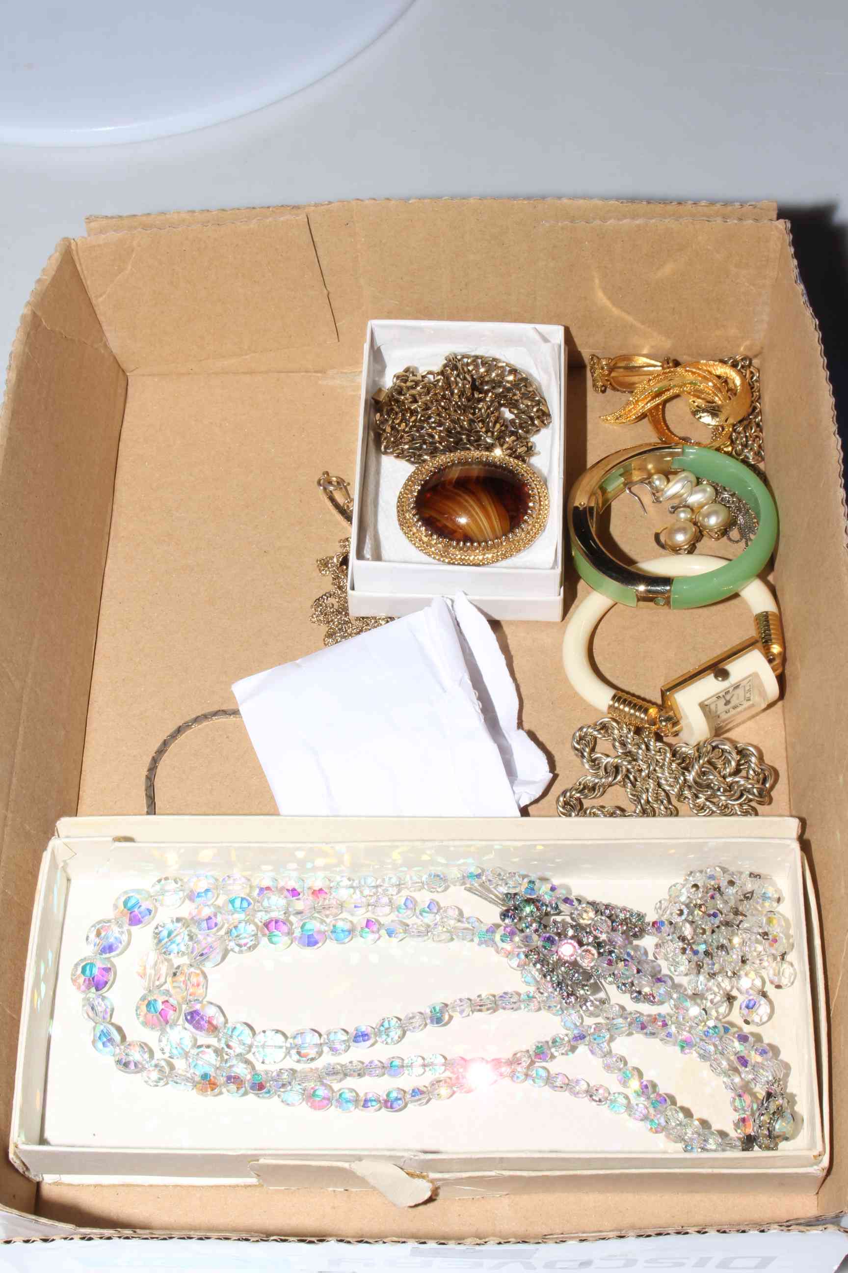 Box of costume jewellery. (Glass necklace and horseshoe charm bracelet withdrawn from lot).