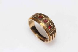 9 carat gold three stone garnet ring, size T.