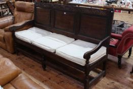 18th Century oak settle with three raised panel back and on turned legs with stretchers, 183cm wide.