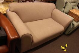 Contemporary two seater settee in mink fabric.