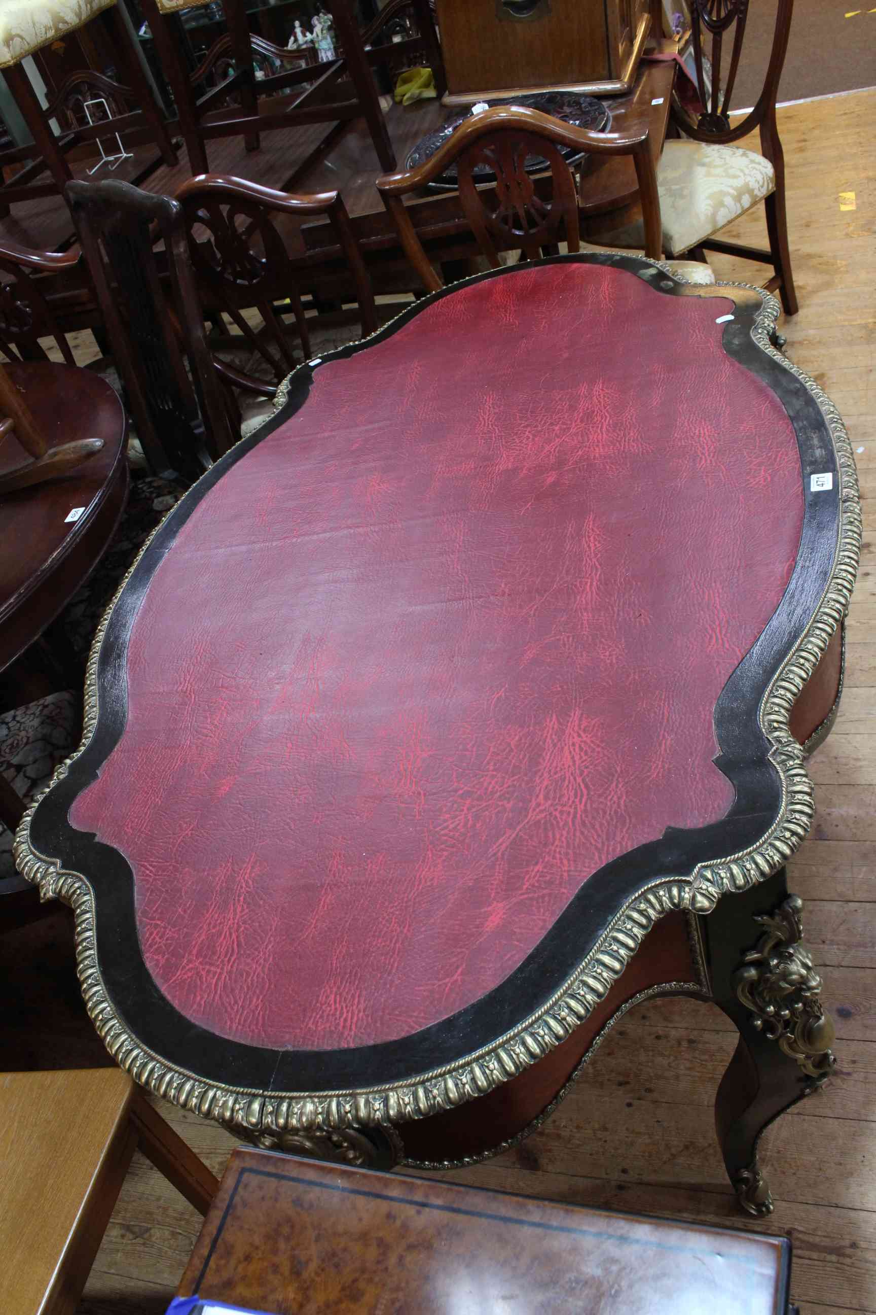 French ebonised and gilt metal mounted bureau plat, of oval shape with inset red leather, - Image 2 of 3