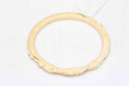 1920's carved ivory bangle with continuous dragon chasing pearl, 9.5cm diameter.