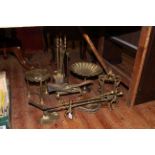 Brassware including ornate easel photograph frame, inkstand, trivets, fire irons, etc.