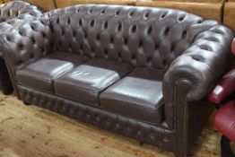 Brown deep buttoned leather three seater Chesterfield settee, 86cm by 192cm by 82cm,