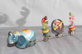 TPS (Japan) clockwork tinplate Elephant towing 3 Clowns. Excellent clockwork motor works.