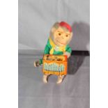 Post War West German clockwork tinplate Monkey playing Barrel Organ.