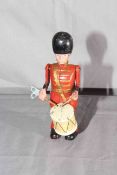 Moko Clockwork die-cast Drumming Guardsman. Excellent clockwork motor works.