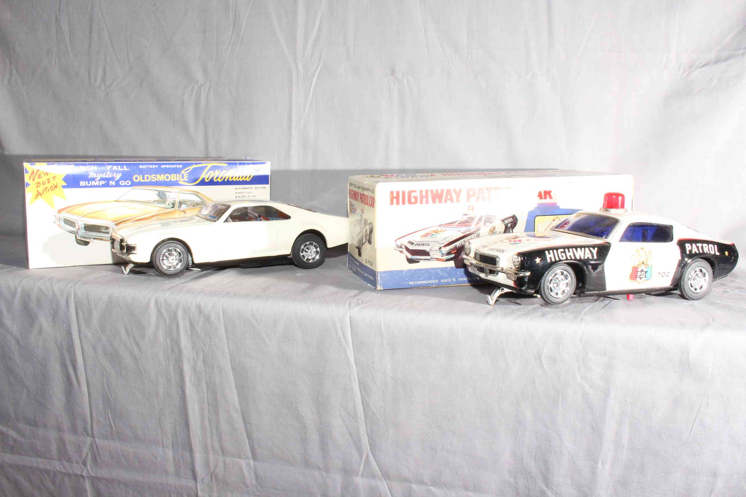 2 Taiyo Japan battery operated Non Fall Mystery Bump Go Cars.