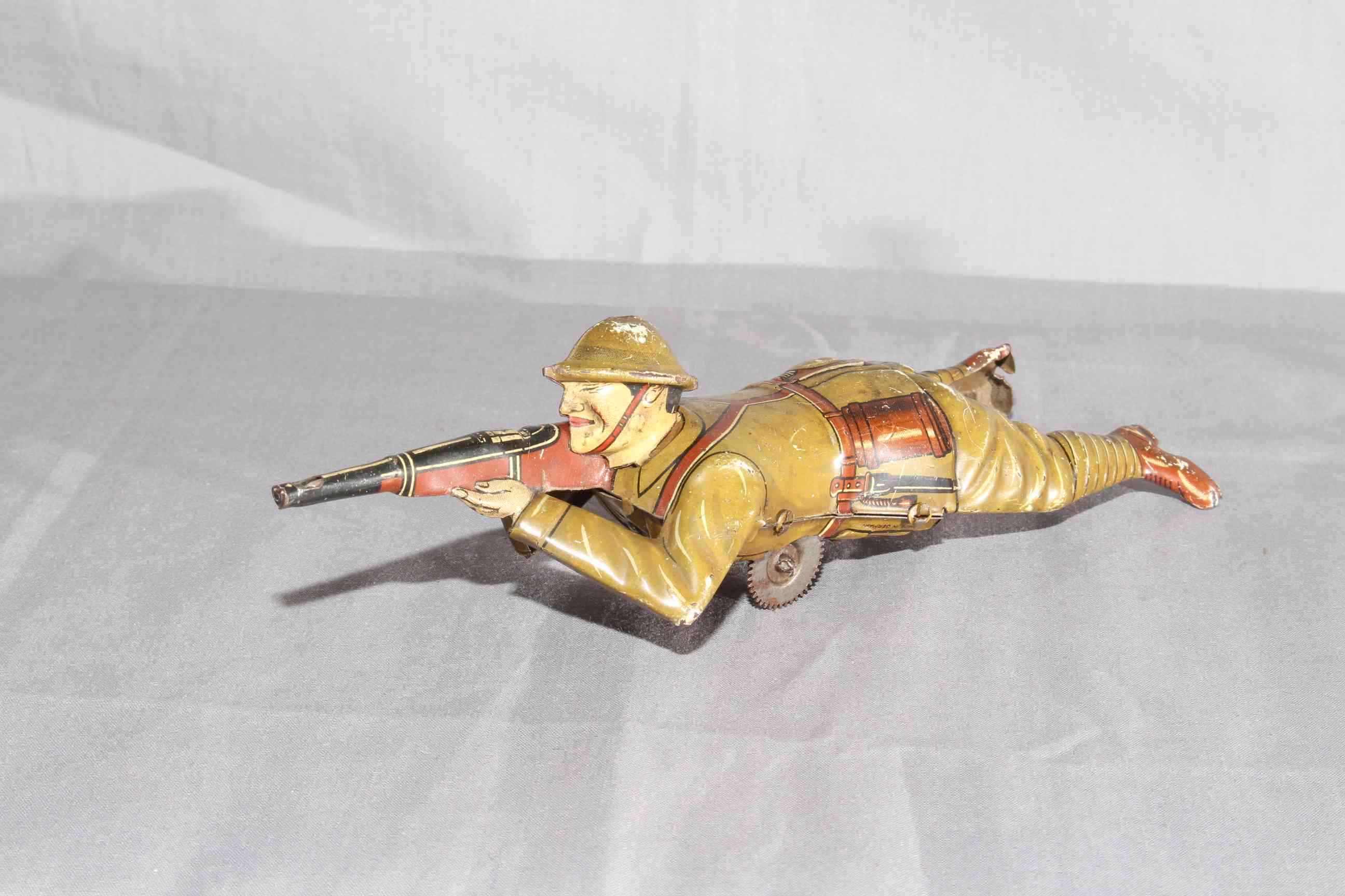 Pre War Einfalt tinplate Sniper with crawling and sparking rifle. Minor wear.