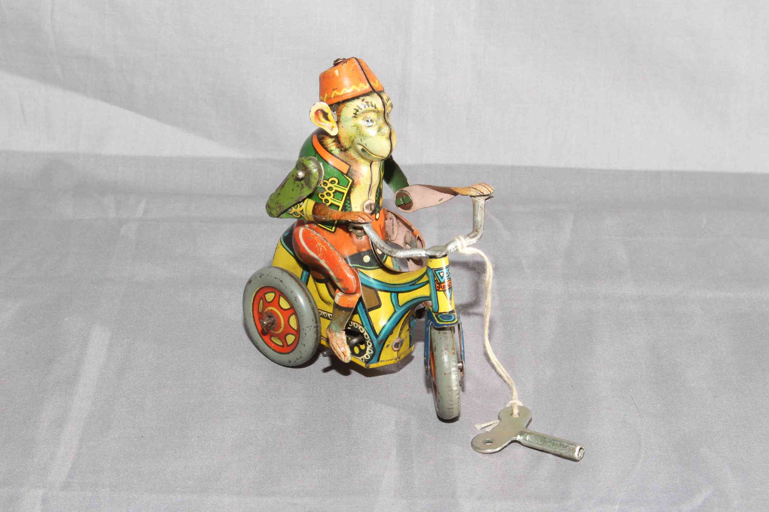 Arnold Germany US Zone clockwork tinplate Monkey on Tricycle. Very Good clockwork motor works.