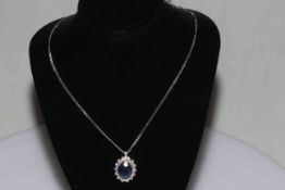 7 carat sapphire and diamond cluster pendant set in 18 carat white gold with 18 carat gold chain.