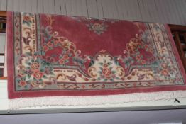 Chinese carpet with a rose pink and floral ground 3.20 by 2.15.