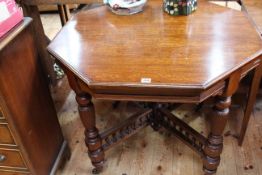 Late 19th/Early 20th Century octagonal oak centre table in turned legs joined by gallery frame, 72.