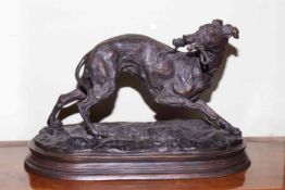 Bronze model of a gun dog carrying it's lead, 19cm high by 30cm by 16cm.