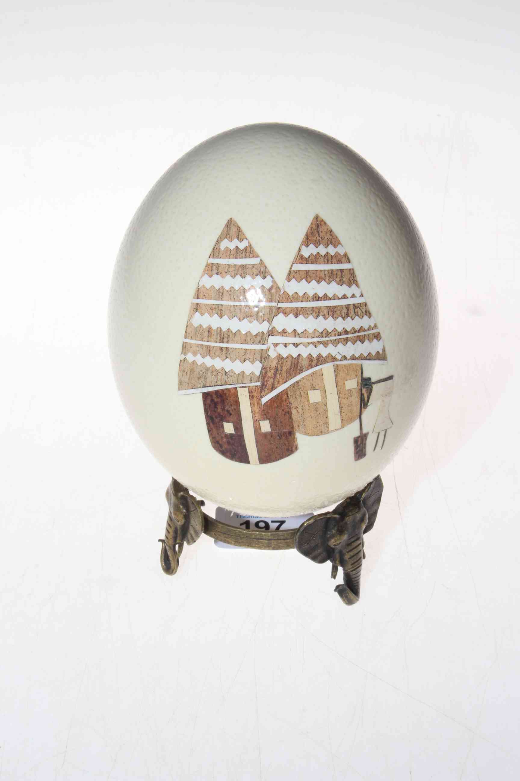 Ostrich egg decorated with figures on metal elephant mask stand. - Image 2 of 2