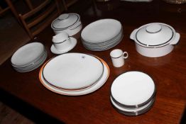 German Pottery dinner service with silvered finish rim and two similar meat plates with orange rims.