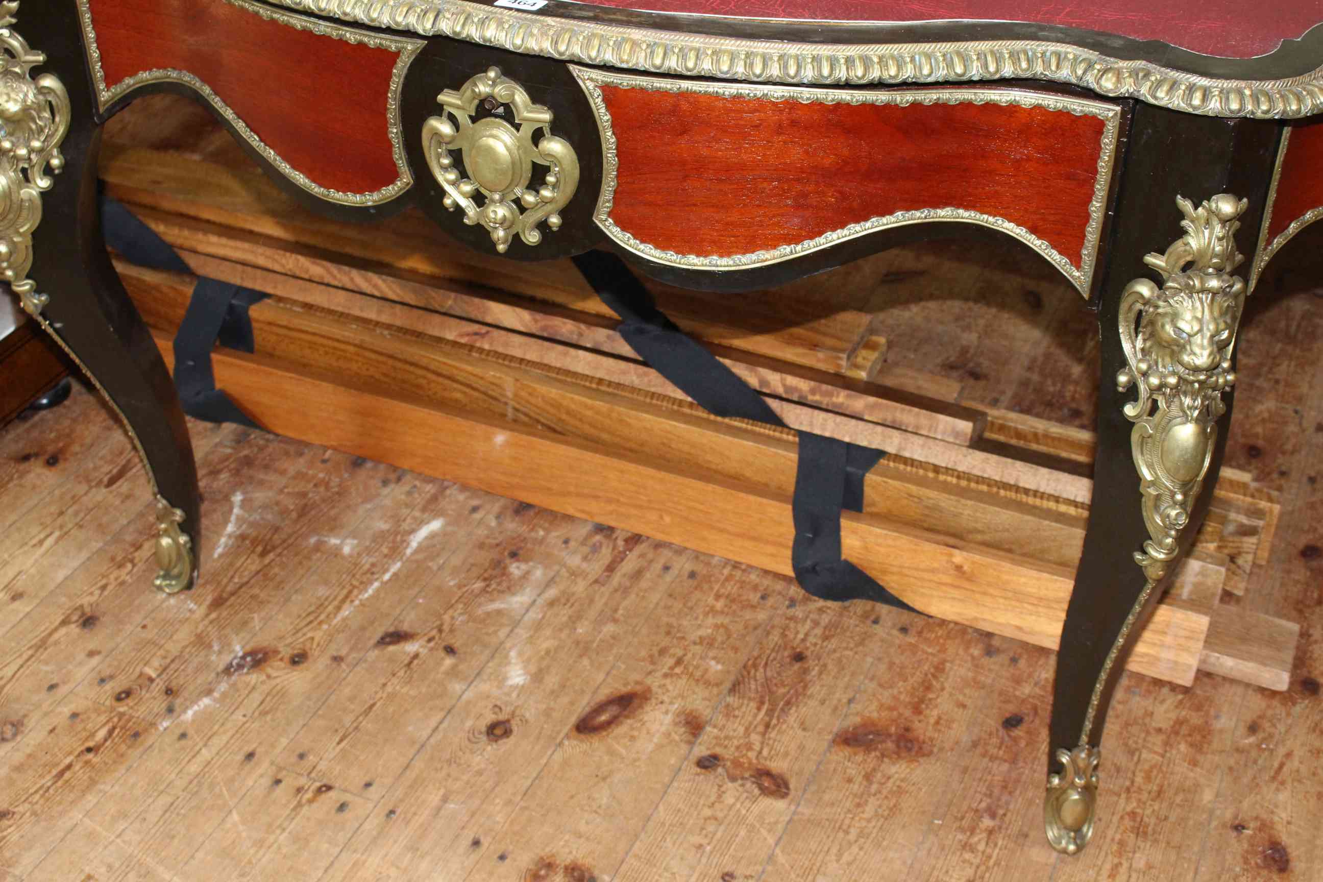 French ebonised and gilt metal mounted bureau plat, of oval shape with inset red leather, - Image 3 of 4