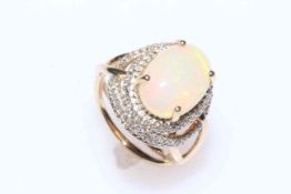 Two 9 carat gold and opal rings, both in fancy settings, one with diamonds and one zircon,