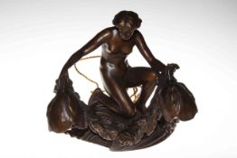 Bronze effect table lamp in the form of naked lady on rocks holding a garland in Art Nouveau style,