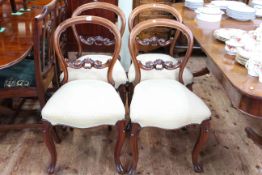Set of four Victorian mahogany balloon back parlour chairs with serpentine front seats.
