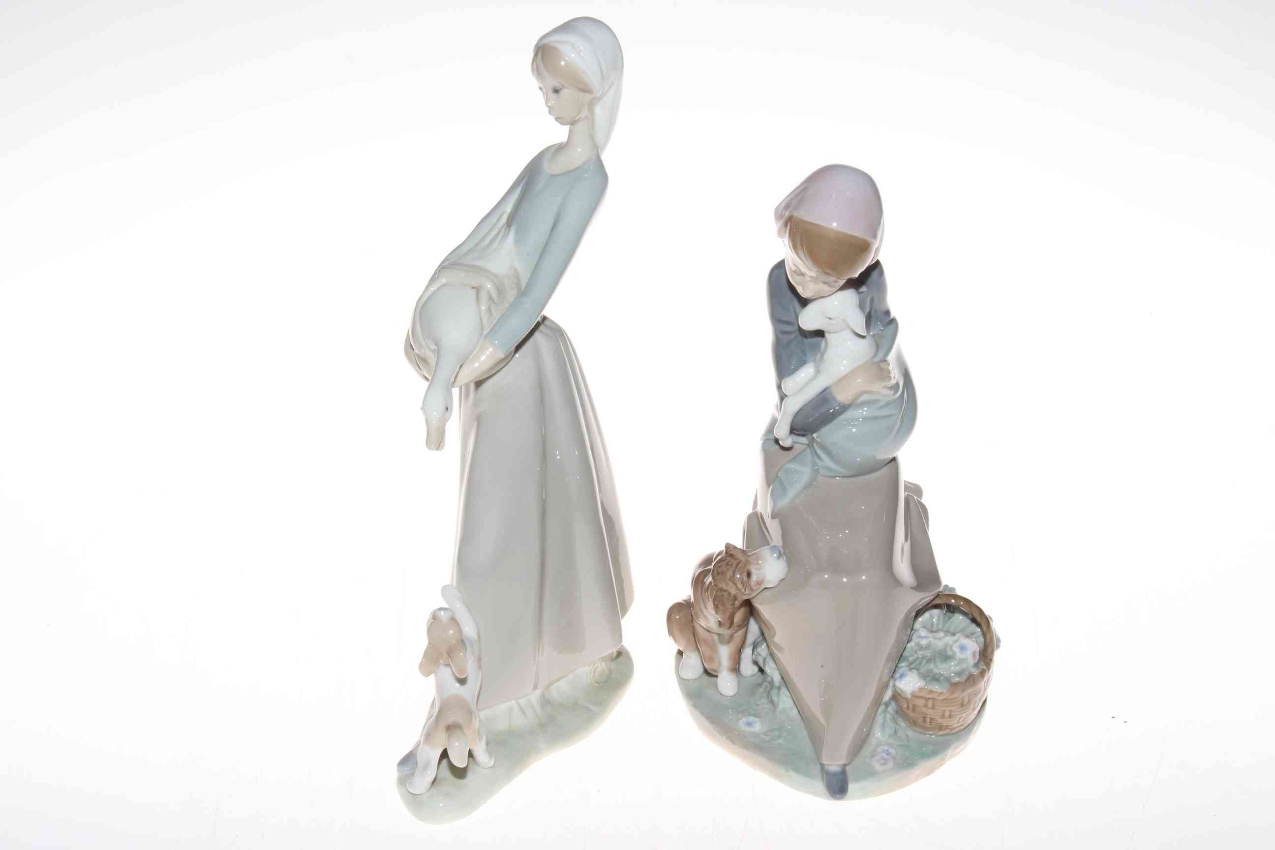 Two Lladro figures, Girl with goose and dog 27cm, and Girl with lamb and dog 23cm, no boxes (2).