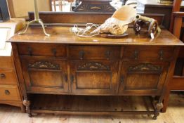 1920's carved oak three door sideboard with raised back, 118cm high by 149cm wide by 46cm deep.