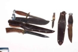 Four knives, three with sheaths, and military style compass.