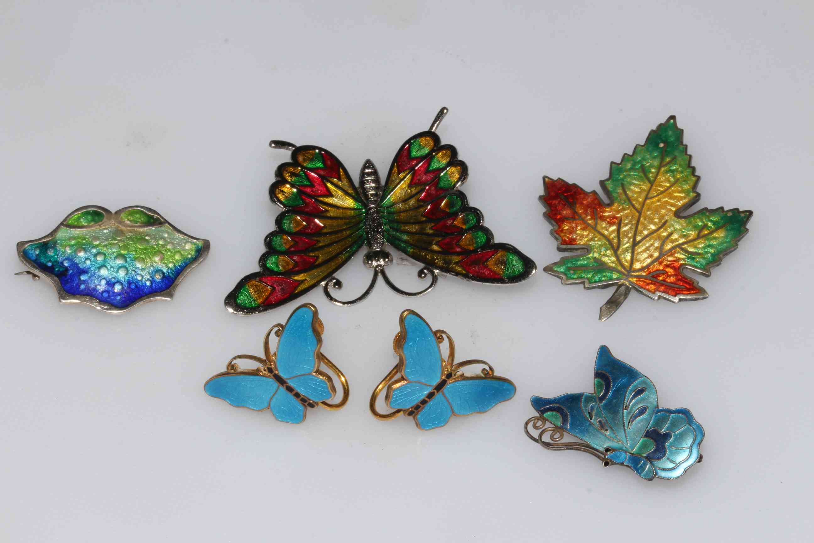 Four enamelled silver brooches, two colourful butterflies,