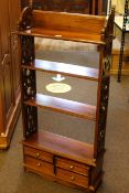 Polished hardwood four drawer open bookcase with fretwork sides, 112.