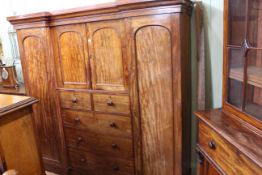 Victorian mahogany inverted breakfront wardrobe having two central arched panel doors above two