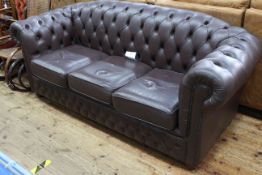 Brown deep buttoned leather three seater Chesterfield settee, 86cm by 192cm by 82cm,