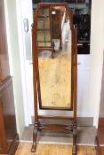 Mahogany cheval mirror raised on square tapering supports.