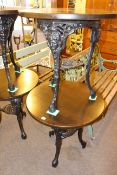 Two little used circular cast base pub tables, 70cm high by 68cm diameter.