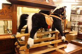 Rocking horse on pine safety stand,